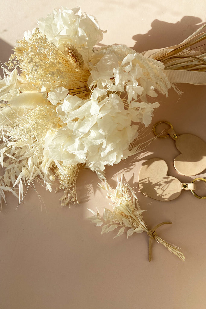 White bridal bouquet, boutonniere and heart keyrings